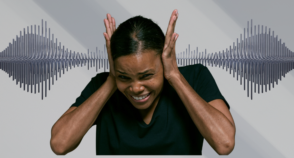 A woman closing her ears due to pain of excessive ringing sound